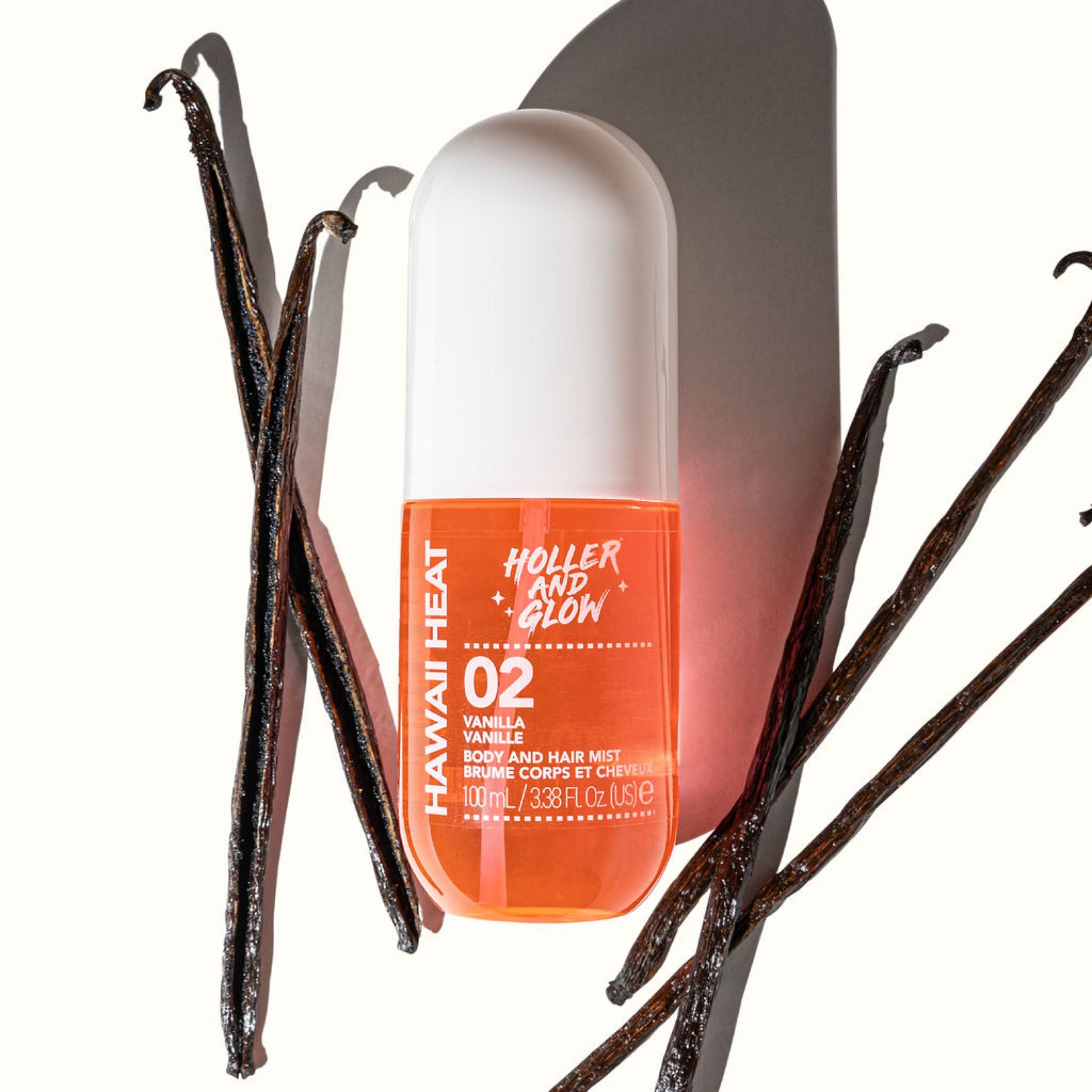 Holler and Glow body and hair mist bottle with vanilla beans on a white background