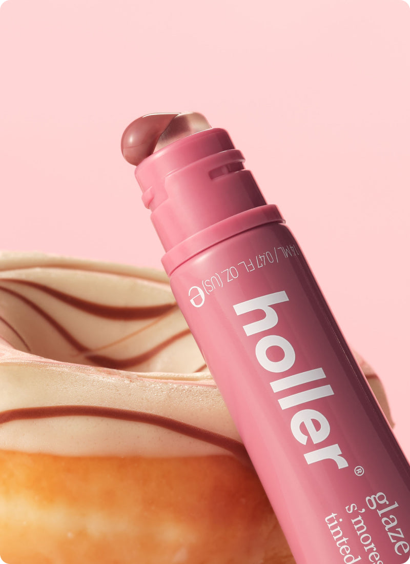Pink lip balm with 'holler' branding on a pink background